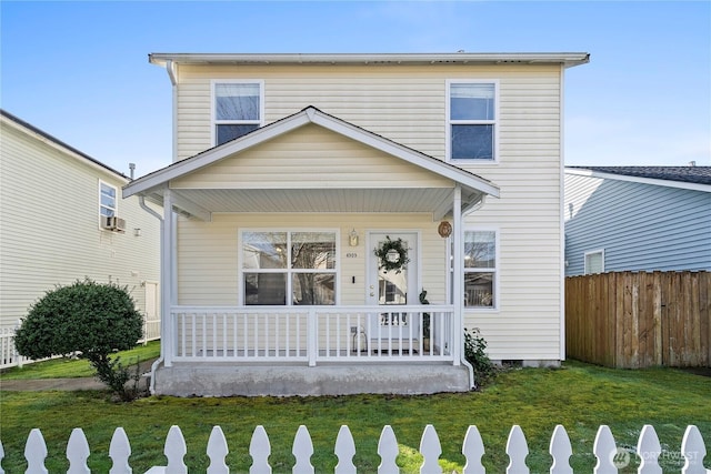 traditional-style house featuring a porch, a front yard, crawl space, and fence