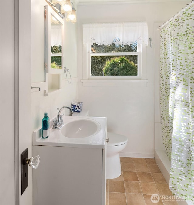 full bathroom featuring toilet, curtained shower, vanity, and tile patterned floors