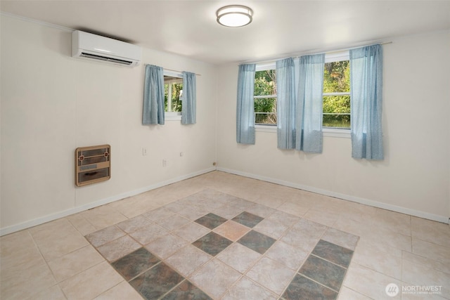 tiled spare room with baseboards, a wall unit AC, and heating unit