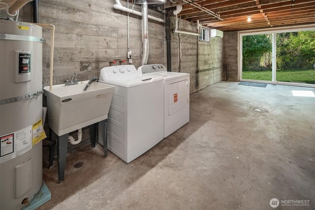 clothes washing area featuring water heater, laundry area, a sink, and washer and dryer