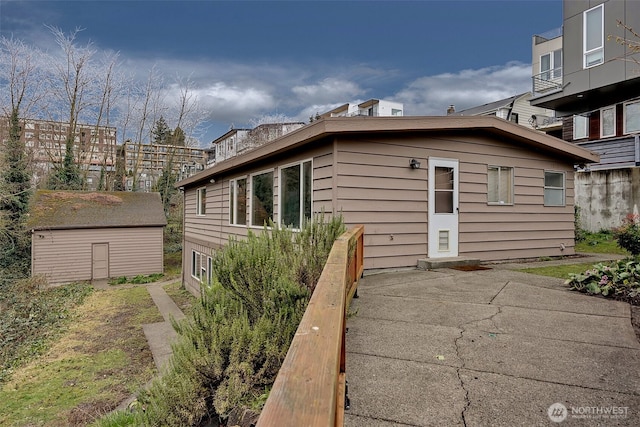 view of side of home featuring an outbuilding