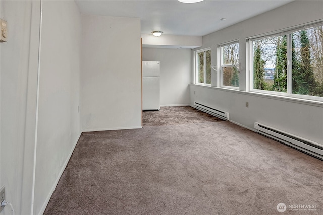 carpeted spare room with baseboards and baseboard heating