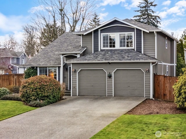 view of front of house featuring driveway, a shingled roof, and fence