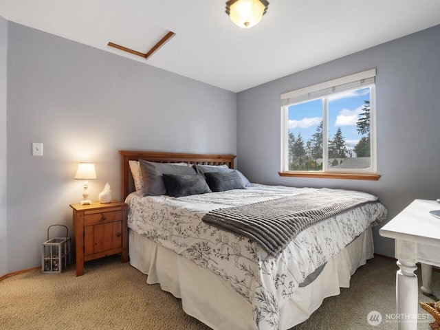 bedroom featuring attic access and carpet