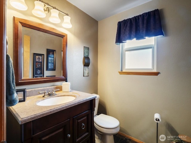 bathroom with toilet and vanity