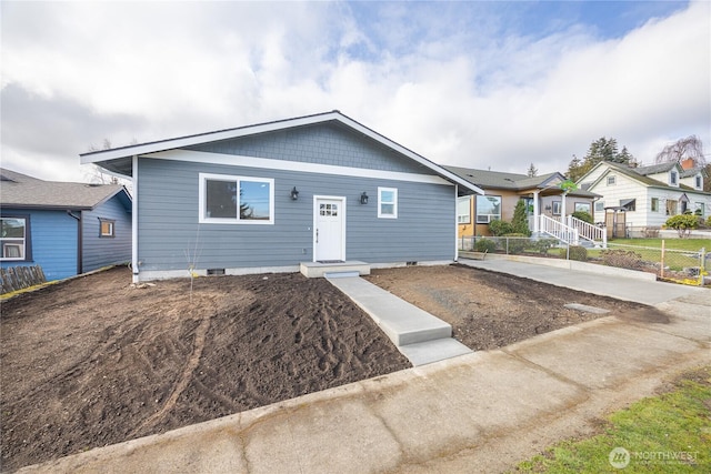 view of front of home featuring fence