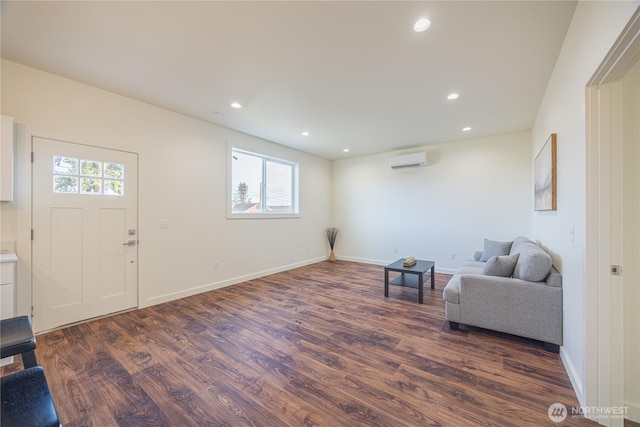 living area featuring a wall unit AC, baseboards, dark wood-type flooring, and recessed lighting