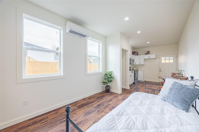 bedroom featuring a wall mounted AC, recessed lighting, dark wood finished floors, and baseboards