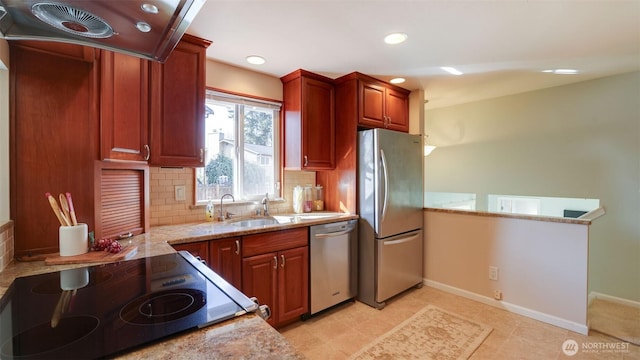 kitchen with light stone counters, stainless steel appliances, backsplash, a sink, and exhaust hood