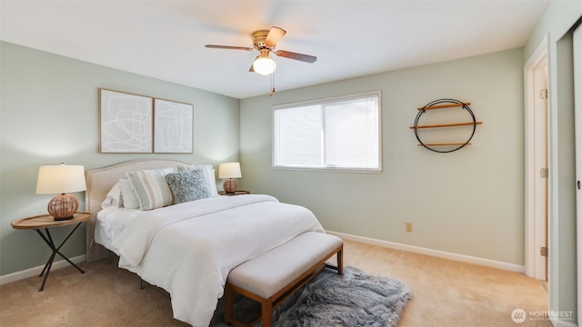 carpeted bedroom with a ceiling fan and baseboards