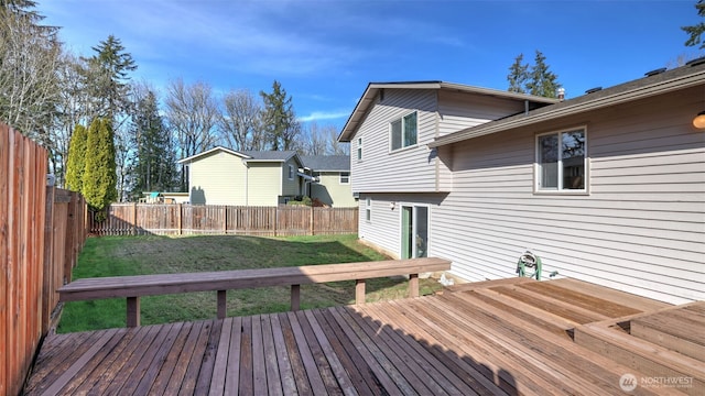 wooden terrace with a fenced backyard and a yard