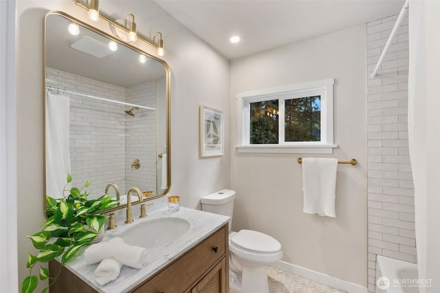 bathroom featuring vanity, toilet, and baseboards