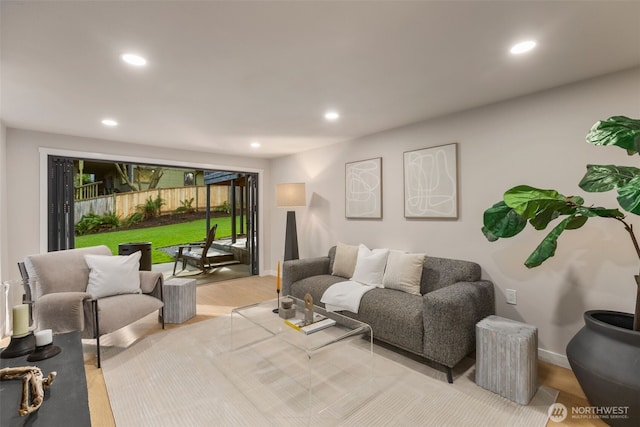 living area featuring baseboards, wood finished floors, and recessed lighting