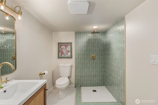 full bath featuring toilet, vanity, tile patterned flooring, tiled shower, and baseboards