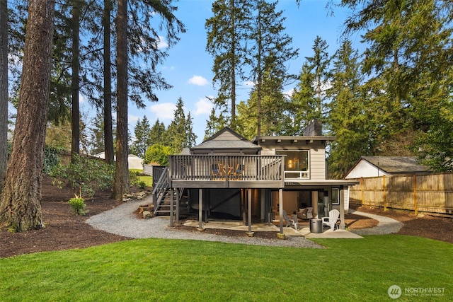 rear view of property with a yard, stairway, a patio area, fence, and a wooden deck