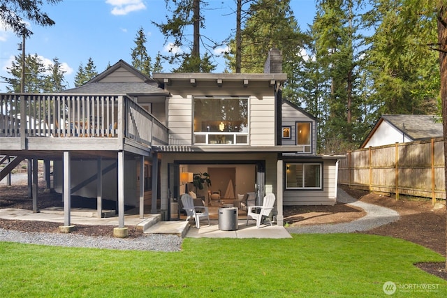 back of property with a patio, a lawn, fence, a deck, and stairs