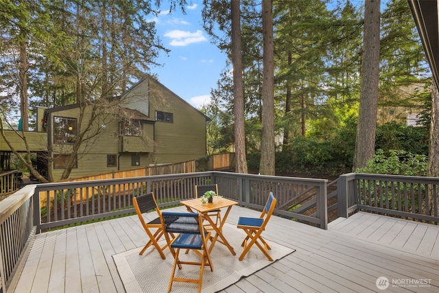 wooden terrace with fence and outdoor dining space