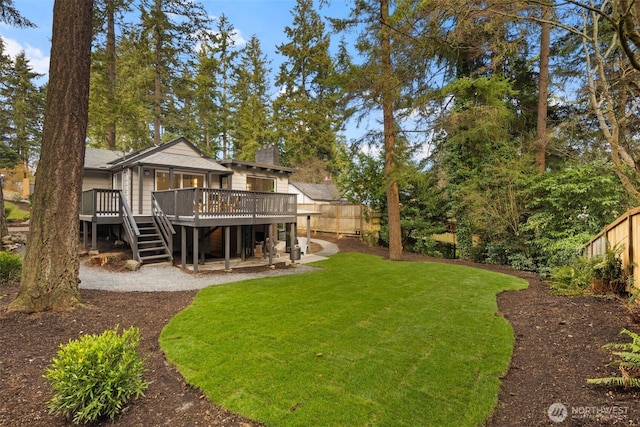 view of yard featuring stairs, a fenced backyard, and a wooden deck