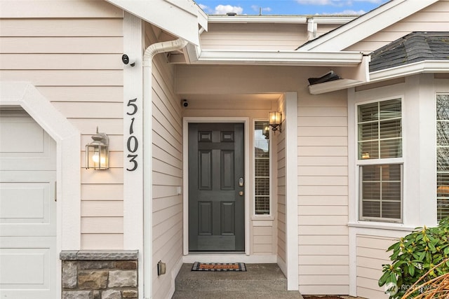 doorway to property with a garage