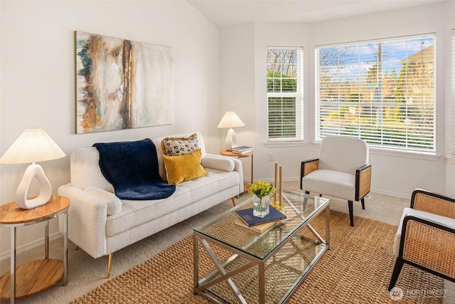 carpeted living area with baseboards