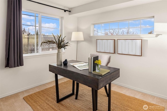 carpeted office space featuring baseboards