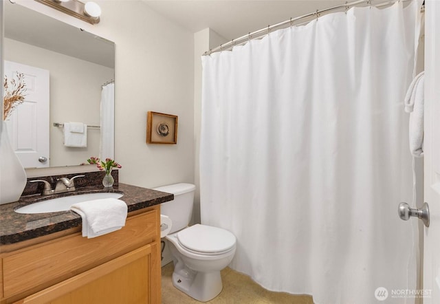 bathroom featuring toilet and vanity