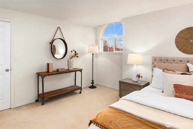 bedroom featuring light carpet and baseboards