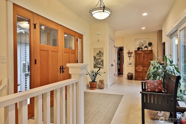 corridor with light tile patterned floors and recessed lighting