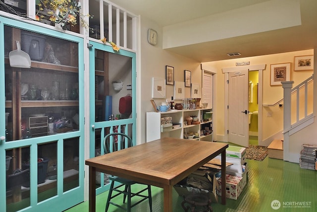 dining area with visible vents and stairs