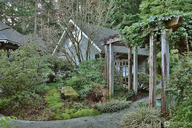 exterior space with roof with shingles