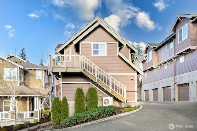 view of front of house with a garage, board and batten siding, stairs, and concrete driveway