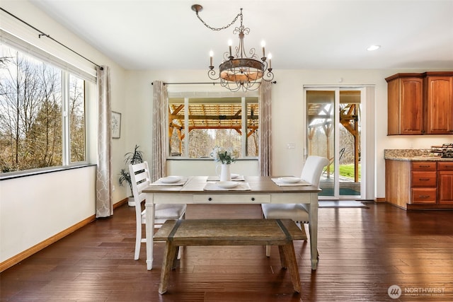 dining space featuring baseboards, dark wood finished floors, a notable chandelier, and recessed lighting