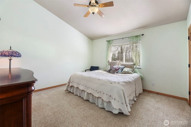 bedroom with light carpet, baseboards, and vaulted ceiling