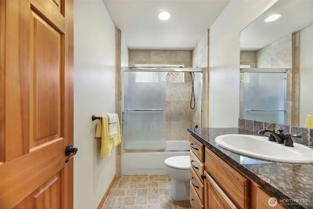 bathroom with toilet, recessed lighting, combined bath / shower with glass door, and vanity