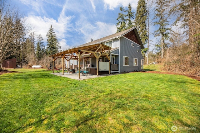 rear view of property with a patio and a lawn