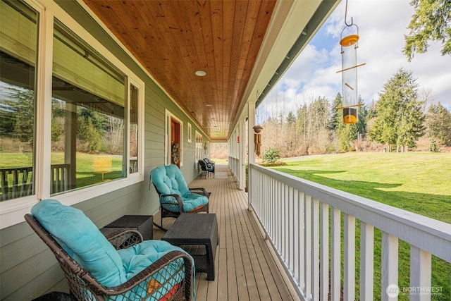 wooden deck featuring a yard