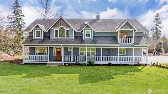 view of front facade featuring a balcony, covered porch, roof with shingles, a front lawn, and a chimney