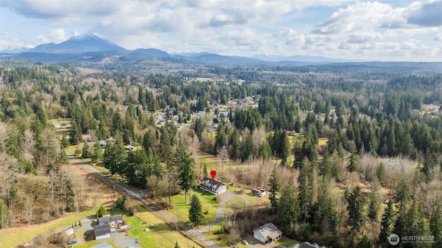 birds eye view of property featuring a mountain view and a forest view