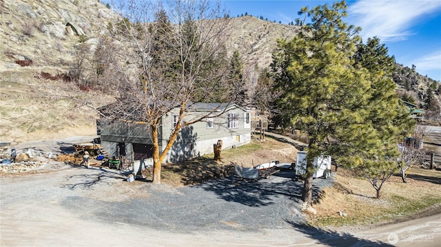 view of side of property featuring driveway and a mountain view