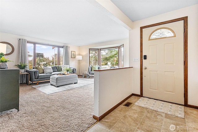 foyer with baseboards, visible vents, and a healthy amount of sunlight