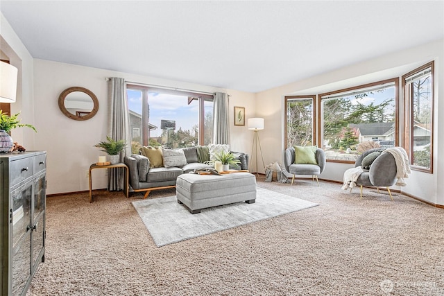 carpeted living room with baseboards