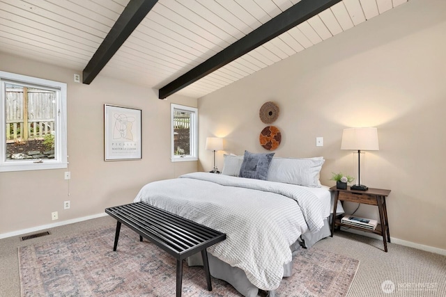 carpeted bedroom with visible vents, vaulted ceiling with beams, and baseboards