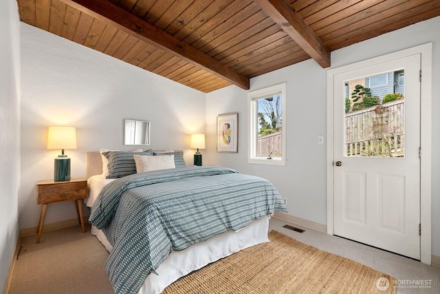 carpeted bedroom featuring beam ceiling, visible vents, wooden ceiling, and baseboards