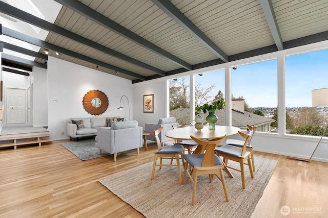 dining room with visible vents, beam ceiling, baseboards, and light wood finished floors