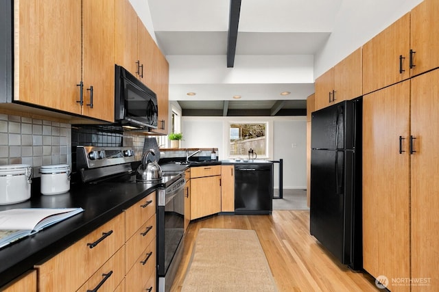 kitchen featuring beamed ceiling, black appliances, light wood-style flooring, dark countertops, and backsplash