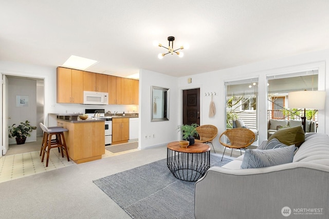 living area with light colored carpet and an inviting chandelier