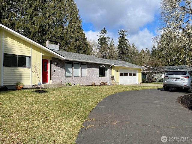 ranch-style house with an attached garage, brick siding, driveway, a front lawn, and a chimney