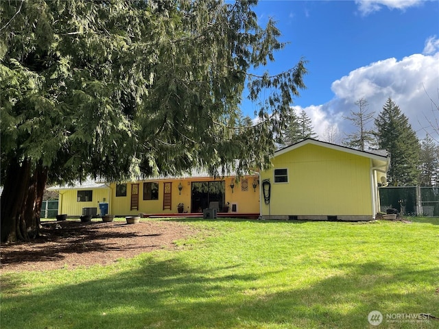 rear view of house featuring crawl space, a yard, fence, and central air condition unit