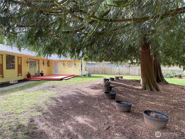 view of yard with a deck and fence