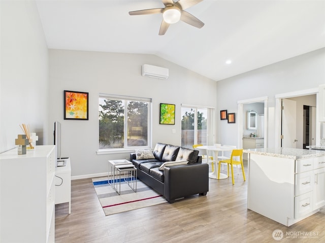 living room featuring a wall unit AC, light wood-style floors, ceiling fan, and vaulted ceiling